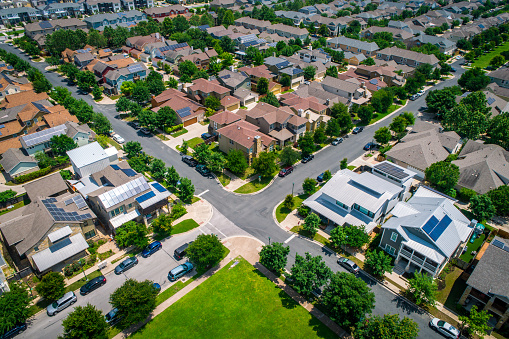 aerial drone view Austin , Texas , USA - Mueller Suburb Intersection with Neighborhoods and Solar Panel Rooftops
