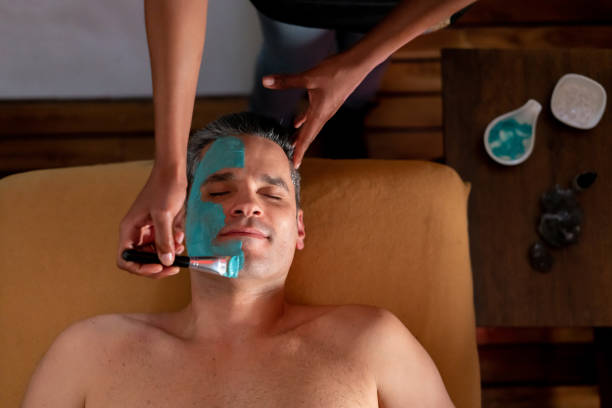 istock Handsome man at the spa getting a facial 1147827326