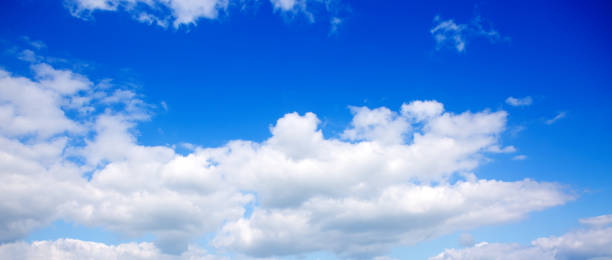 istock Big white fluffy clouds in the blue sky. 1147829720