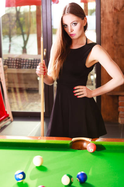 istock Young woman posing having fun with billiard. 1147829806