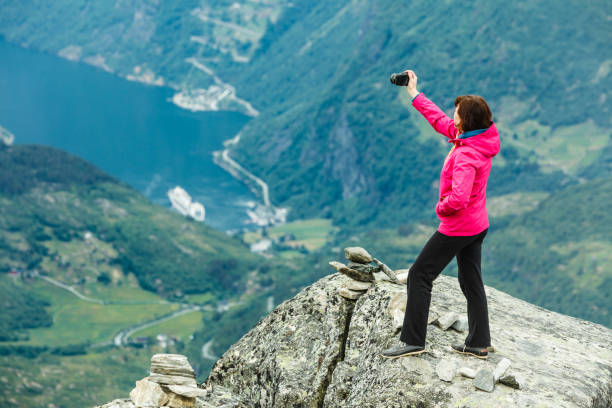 istock Tourist taking photo from Dalsnibba viewpoint Norway 1147829848