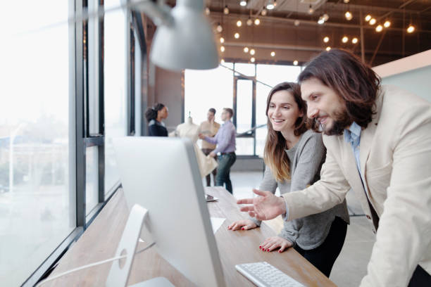 istock Colleagues working in fashion design studio office 1147831804