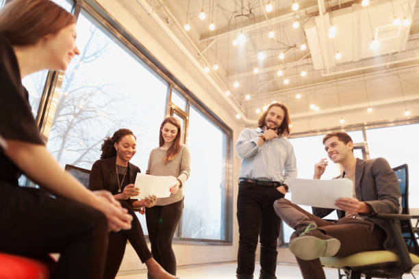 istock Group of coworkers talking together in studio environment 1147831940