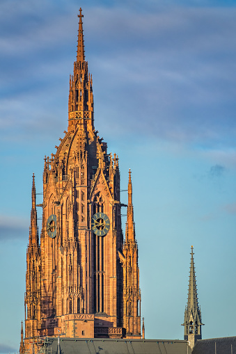 Stock photograph of the Gothic tower of the historic Kaiserdom in downtown Frankfurt am Main Germany on a sunny day.