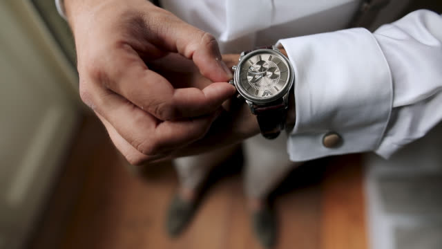 Well Dressed Man Checking Time On His Wrist Watch
