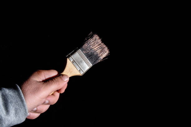 istock Hand holding painting brush 1147835872
