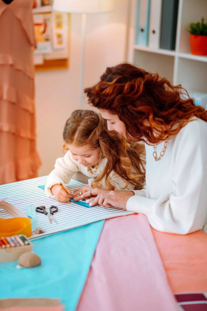 istock Mother designing clothes for new collection with daughter 1147836191