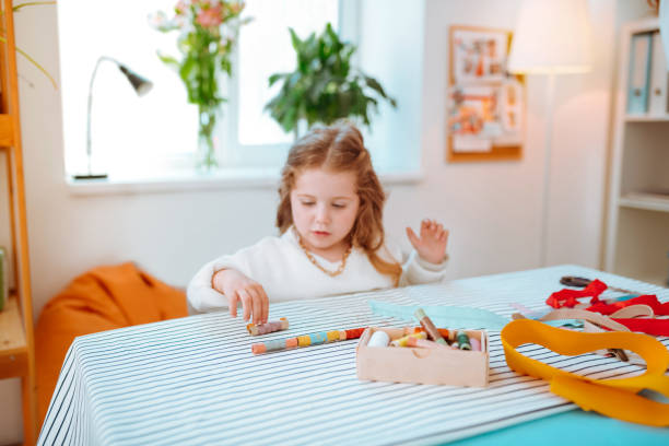 istock Funny girl playing with colorful threads visiting mom at work 1147836248