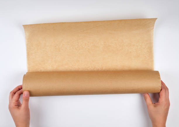 istock two hands hold a large roll of brown parchment paper 1147837685