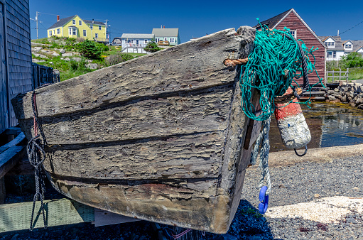 Old fishing dory docked on the shore of Peggys Cove, Nova Scotia.