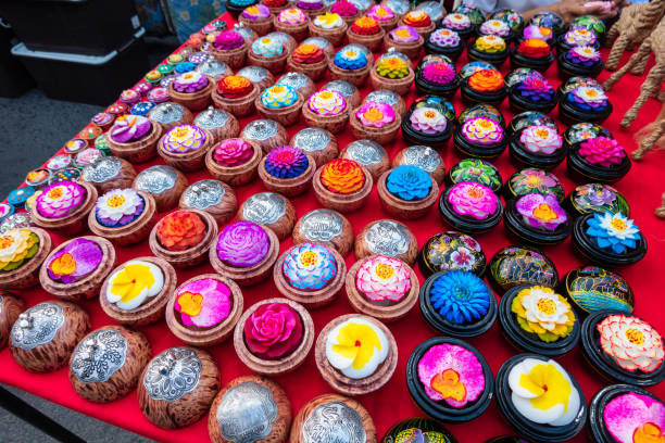 Traditional Thai handmade souvenir soap carved and painted as flowers in hardwood painted and varnished gift boxes presented on night market