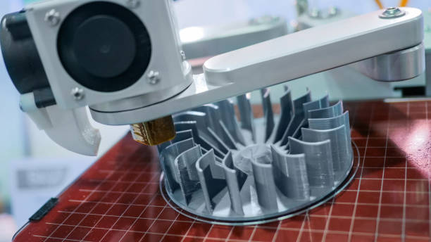 3D manufacturing printer during work 3D printer machine printing plastic workpiece look like metal at futuristic technology exhibition - close up shot. 3D printing, 4.0 industrial revolution and manufacturing concept 3d printing photos stock pictures, royalty-free photos & images
