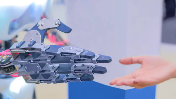 istock Woman and robot hands 1147841865