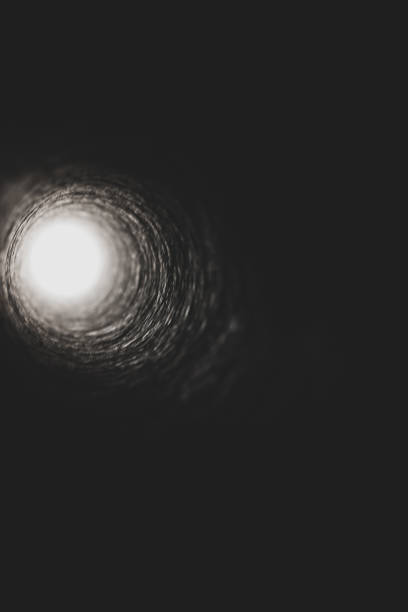 istock Looking down a cardboard tube towards a bright source of light 1147842821