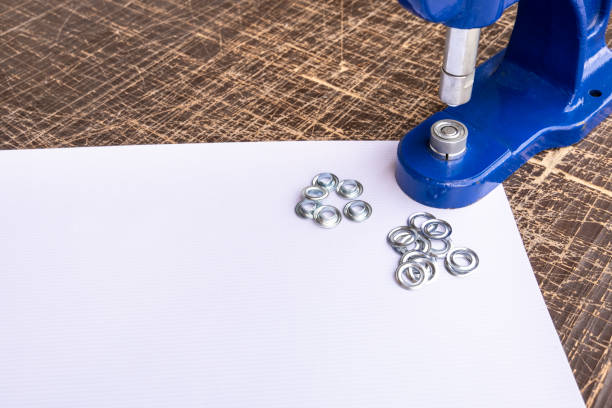 istock Close up hand press eyelet machine and eyelets details 1147845704