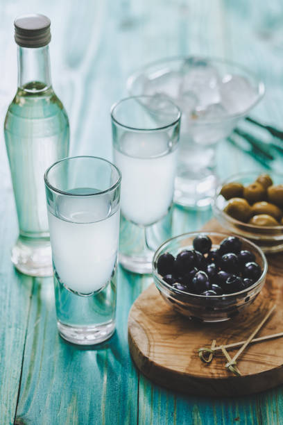 Greek Ouzo and Olives Favorite Greek summer drink Ouzo, flavor liquor made with the anise plant , served with Kalamata olives serbian raki stock pictures, royalty-free photos & images
