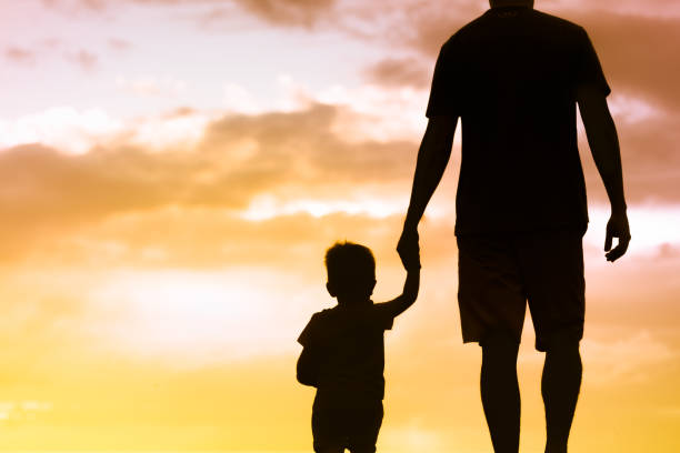 istock Father holding hands with his little son 1147846772