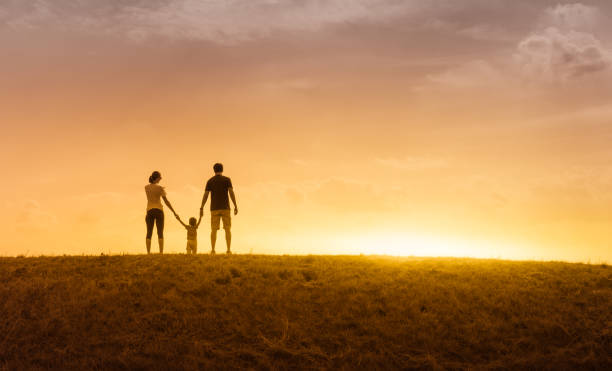 istock Happy family at sunset 1147846838
