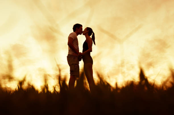 istock Romantic couple kissing at sunset 1147846862