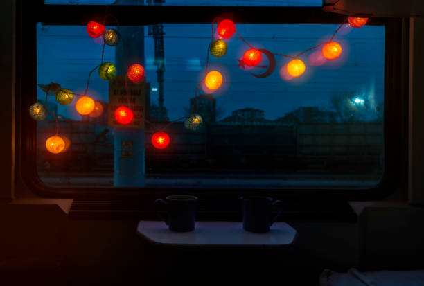 Bright and colorful lights in front of the train's window at dark night stock photo