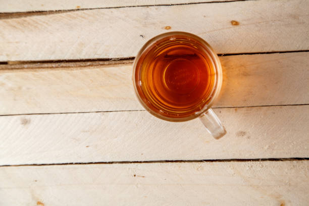 istock tea in transparent glass on a wooden background 1147849847