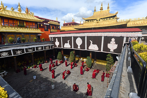 Monks debate in the courtyard of the The Jokhang, also known as the Qoikang Monastery, is a Buddhist temple in Barkhor Square in Lhasa, the capital city of Tibet. Tibetans, in general, consider this temple as the most sacred and important temple in Tibet.