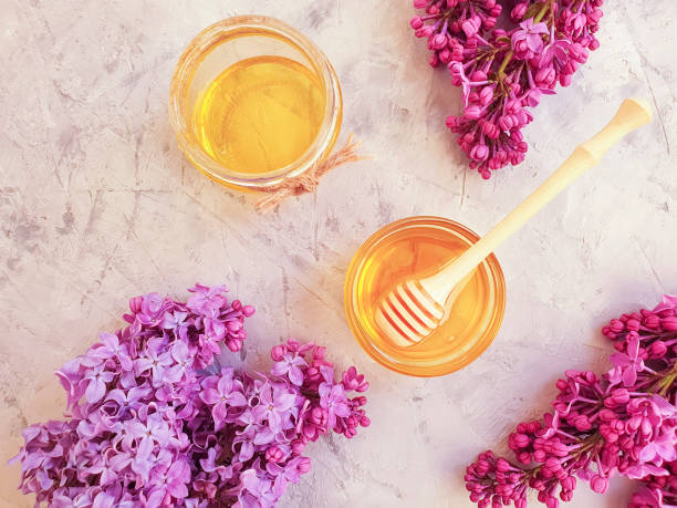 istock fresh natural honey, blooming lilac on a gray concrete background 1147851030