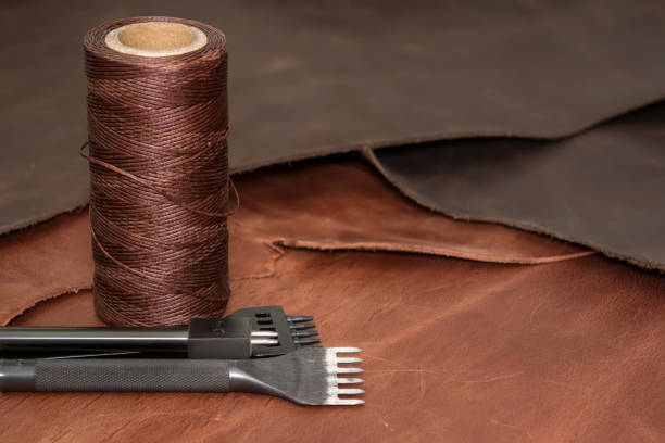 istock Natural leather, tools for creating products and bobbins of wax yarns. 1147852305