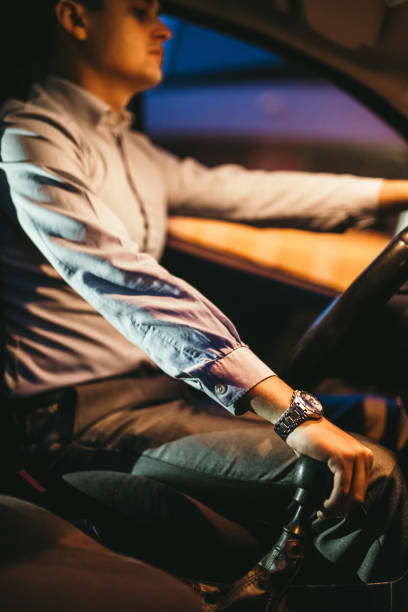 istock Dark elegant man driving car 1147852573
