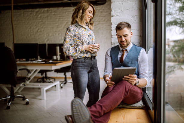 istock Business man sitting by the window and using digital tablet 1147854903