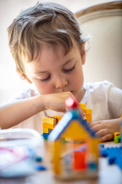 istock Three years old child playing with his toys 1147858565