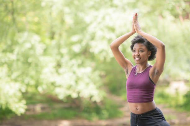 istock Woman meditates in the park 1147858836