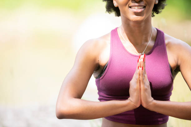 istock Woman meditates in the park 1147858839