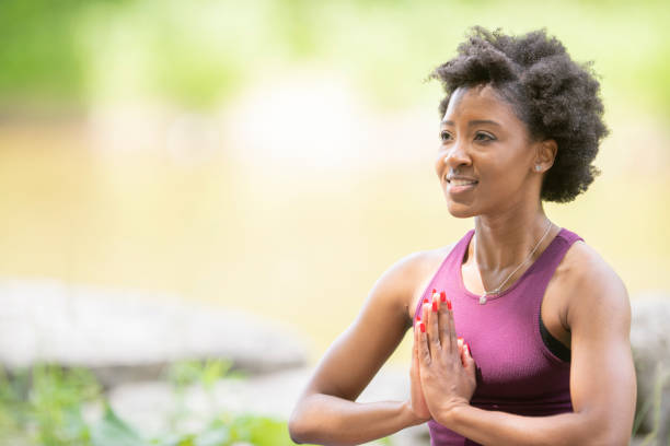 istock Woman meditates in the park 1147858853