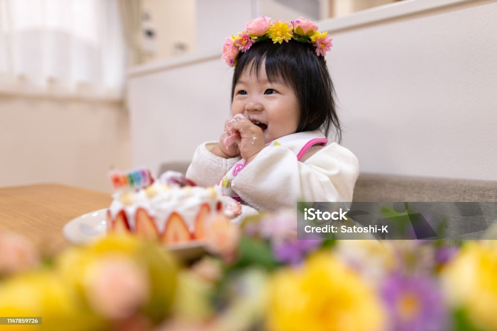 Baby girl smashing cake for her first birthday Demolishing Stock Photo