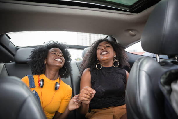 istock Young afro women having fun while dancing during a road trip in the car 1147865353