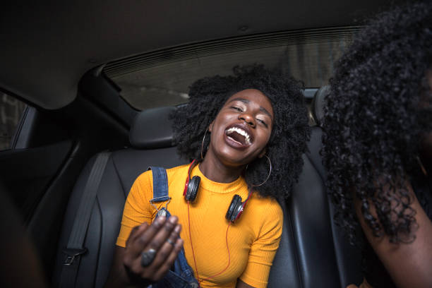 istock Young afro women having fun while dancing during a road trip in the car 1147866722
