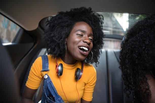 istock Young afro women having fun while dancing during a road trip in the car 1147866723
