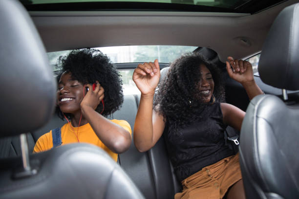 istock Young afro women having fun while dancing during a road trip in the car 1147866724