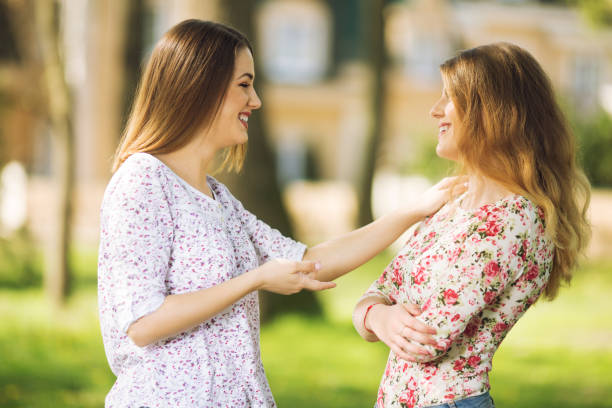 istock Two young women talking and laughing 1147868582