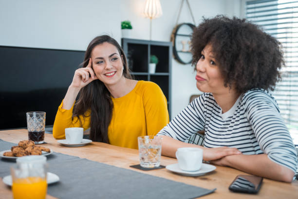 istock Friends talking in the kitchen and eating chips 1147876552