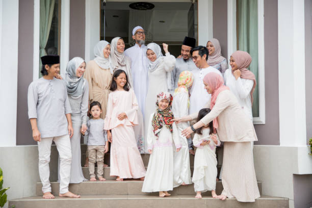 Family standing in front of house during raya celebration in Malaysia