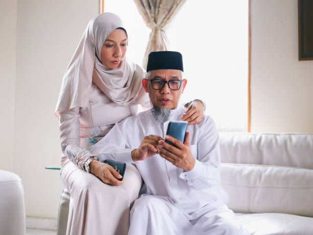istock Father and daughter looking at phone 1147885061