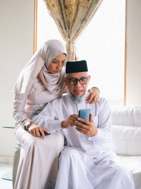istock Father and daughter looking at phone 1147885102