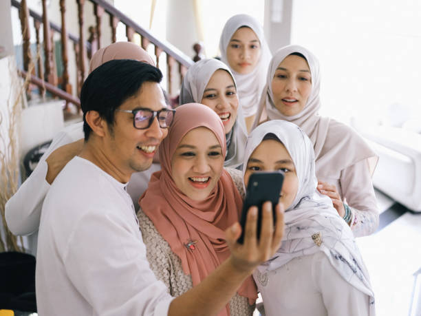 Family selfie and laughing Family selfie and laughing during raya celebration in Malaysia hari raya family stock pictures, royalty-free photos & images