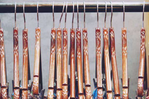 istock Colorful shirts hanging on rack close up 1147888366