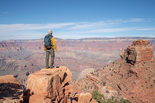 Young man travels in USA and contemplates the famous Grand Canyon, United States, people travel explore nature