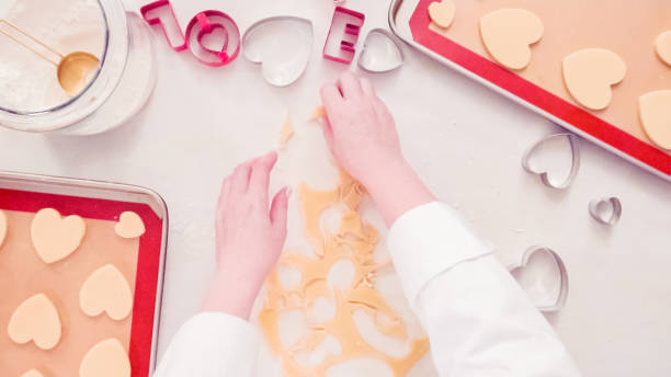 istock Cutting out shapes from sugar cookie dough with cookie cutters. 1147891257