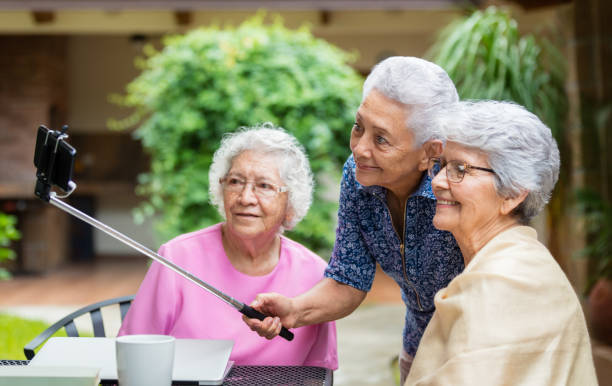 istock Three latin senior women taking selfie outside 1147891370