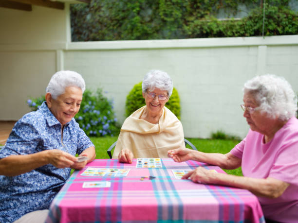 istock Three elderly women playing mexican lottery at a table outdoors 1147891411